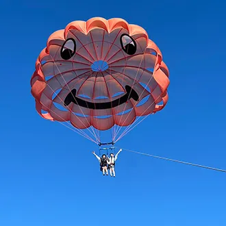 沖縄の青い空をパラセーリングで空中散歩
